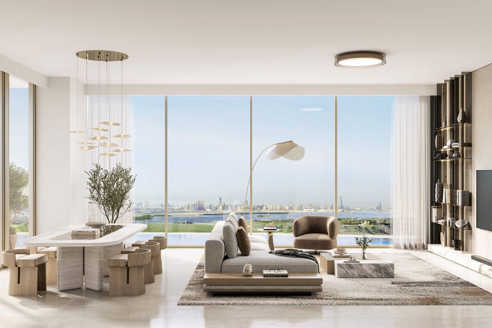 Open-plan living and dining room with full-height windows facing the water