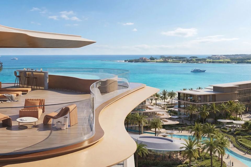 Terrace lounge overlooking the beach, sea and low-rise buildings of the development