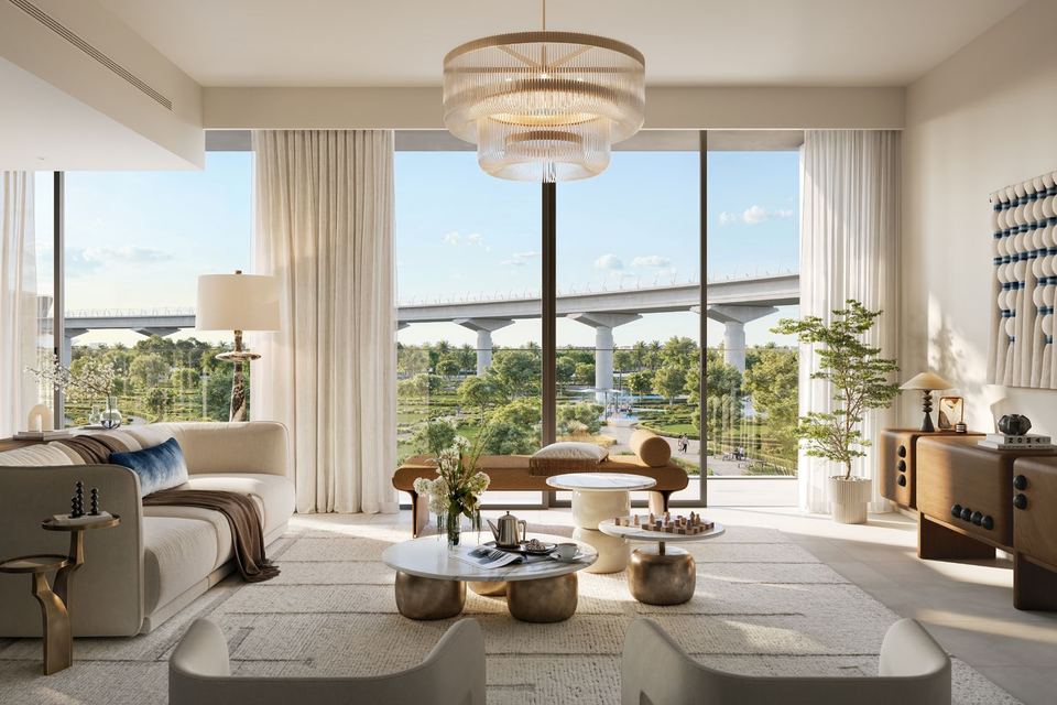 Living room with floor-to-ceiling windows looking over greenery