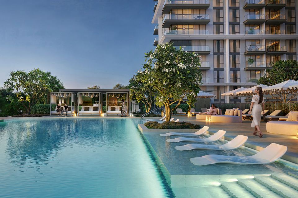 Pool with sun loungers beside the residential building