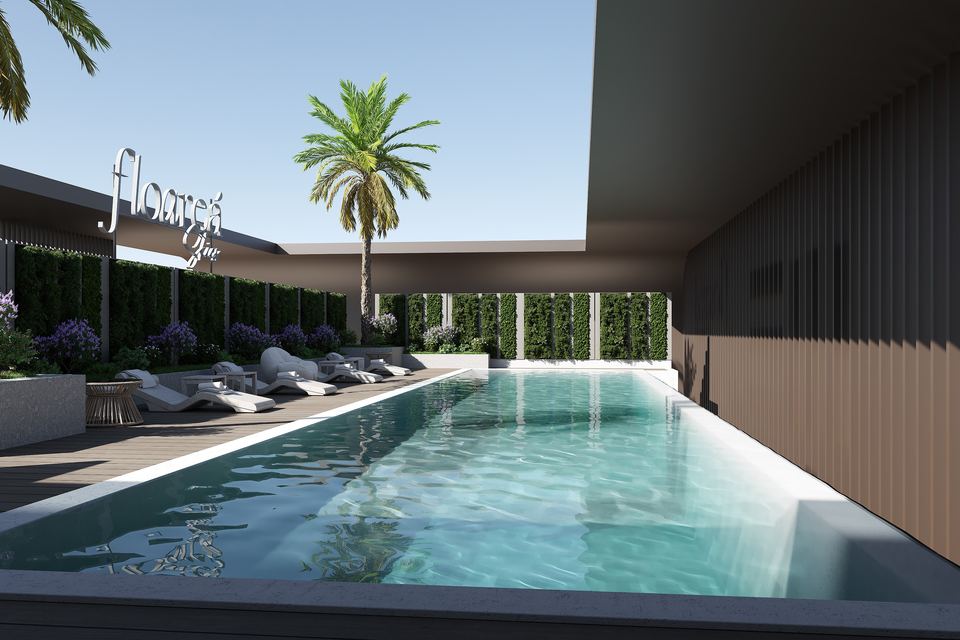 Rooftop pool at Floareá Skies with loungers and a palm