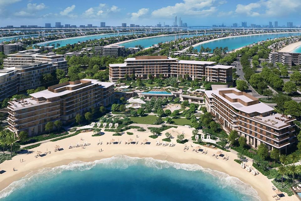 Aerial view of low-rise buildings on Palm Jebel Ali's central island with beaches and fronds